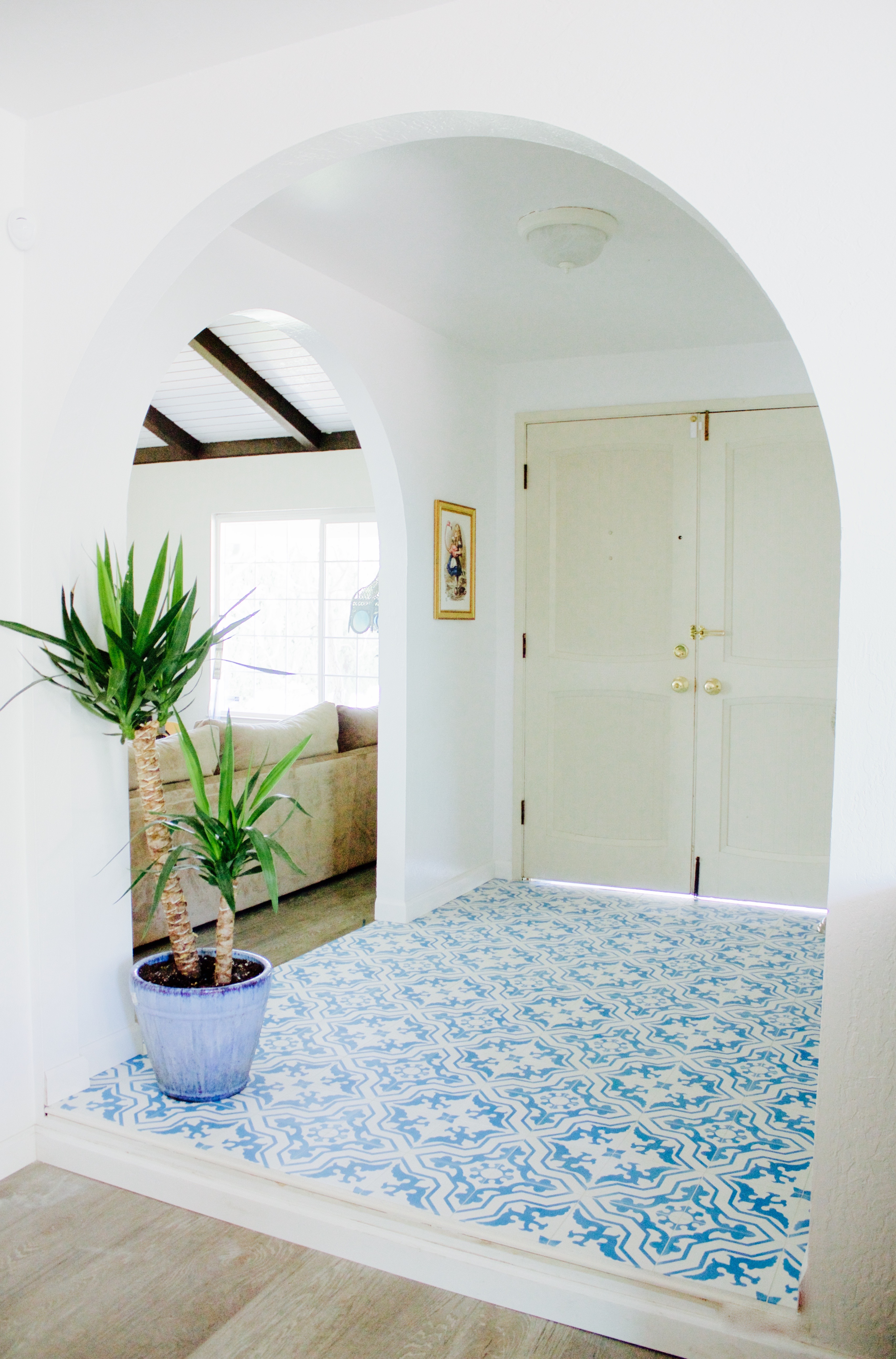 Bold blue and white entryway tile with white walls