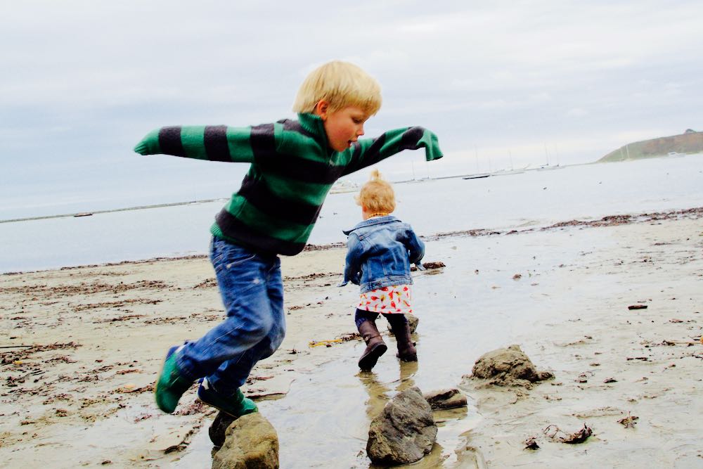 Kids playing on the beach in the winter